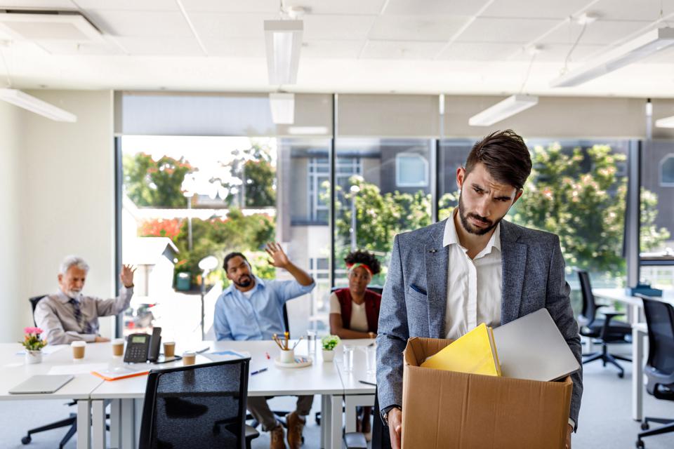 Workers at the office and one of them being fired